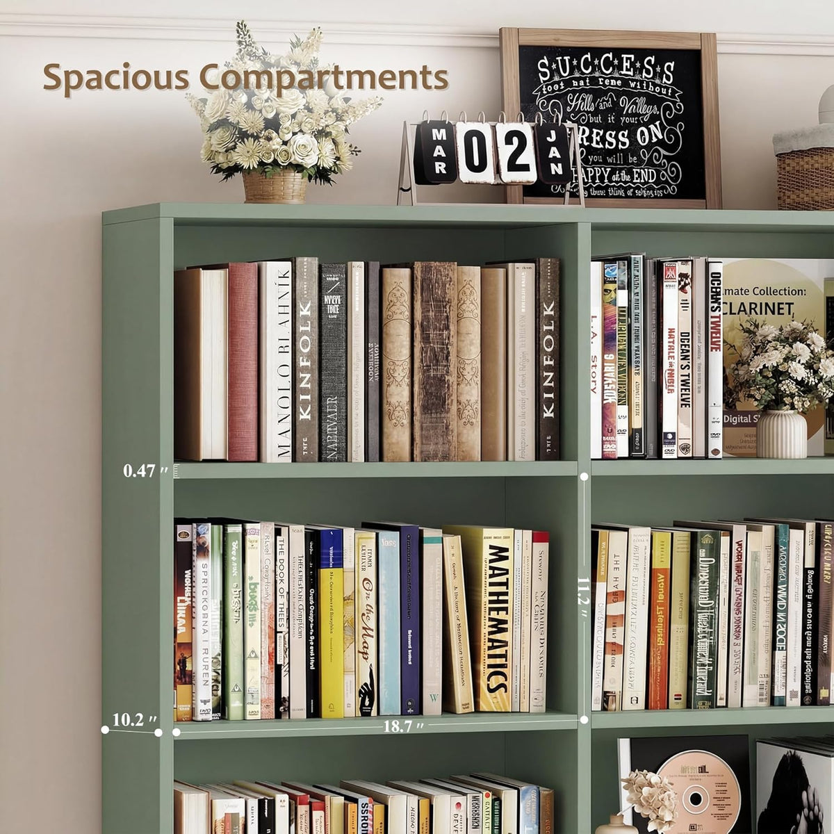 Close-up of the green bookcase shelves with measurement markers indicating compartment widths and heights.