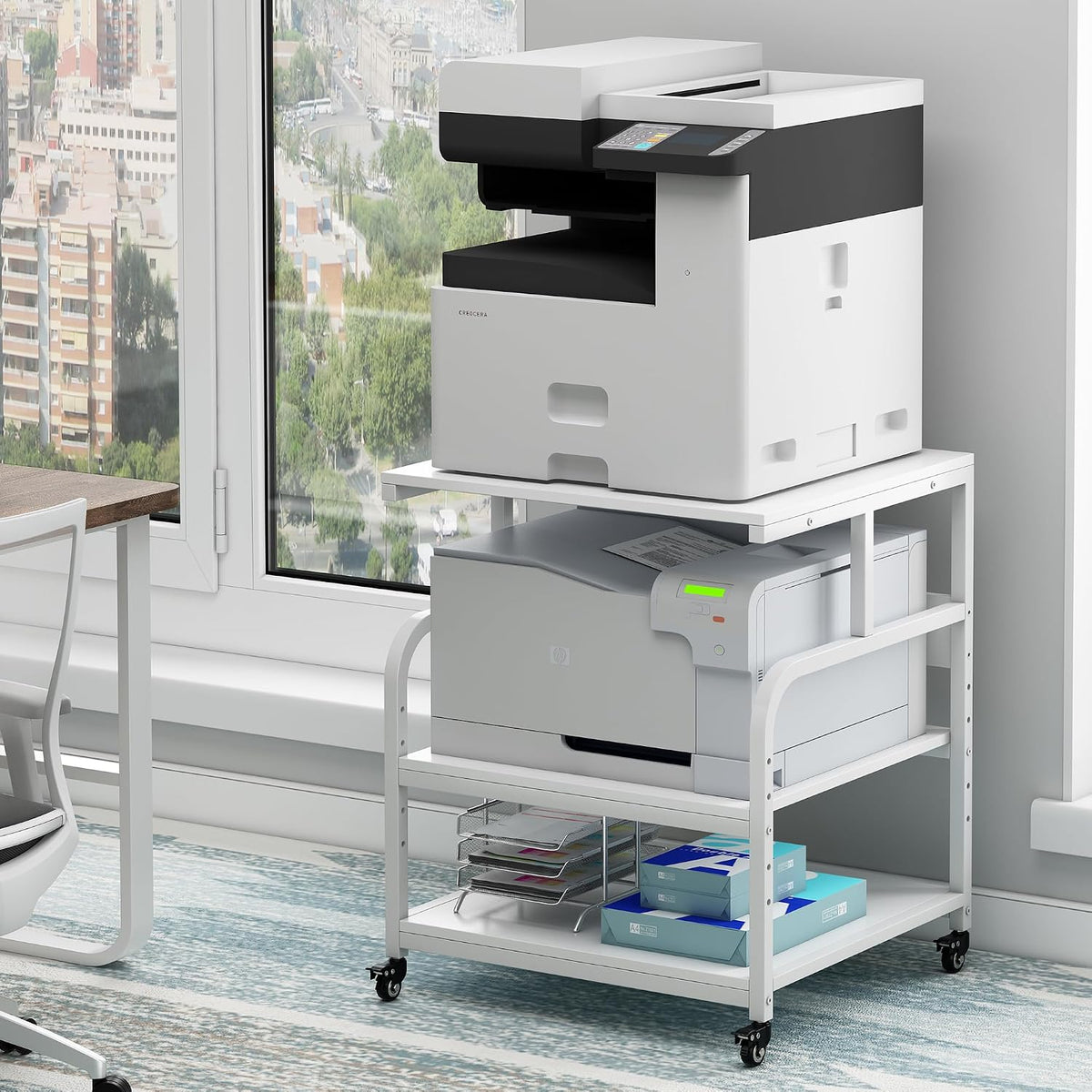 White-framed 3-tier stand with white shelves holding two printers and paper reams beside a desk.