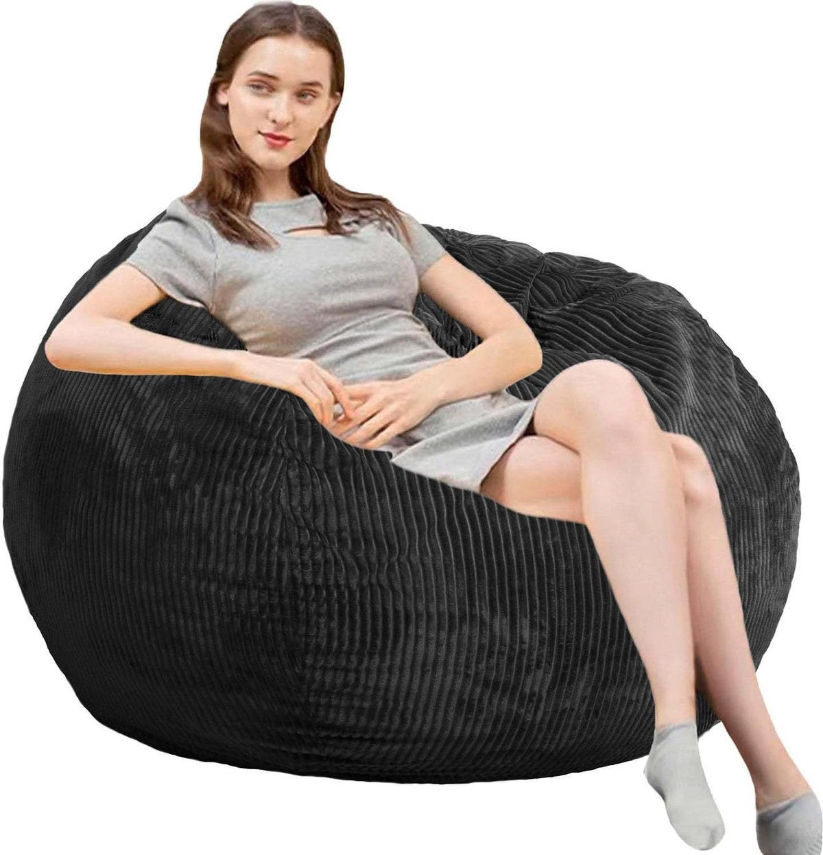 Young woman reclining in a large dark charcoal ribbed round bean bag chair