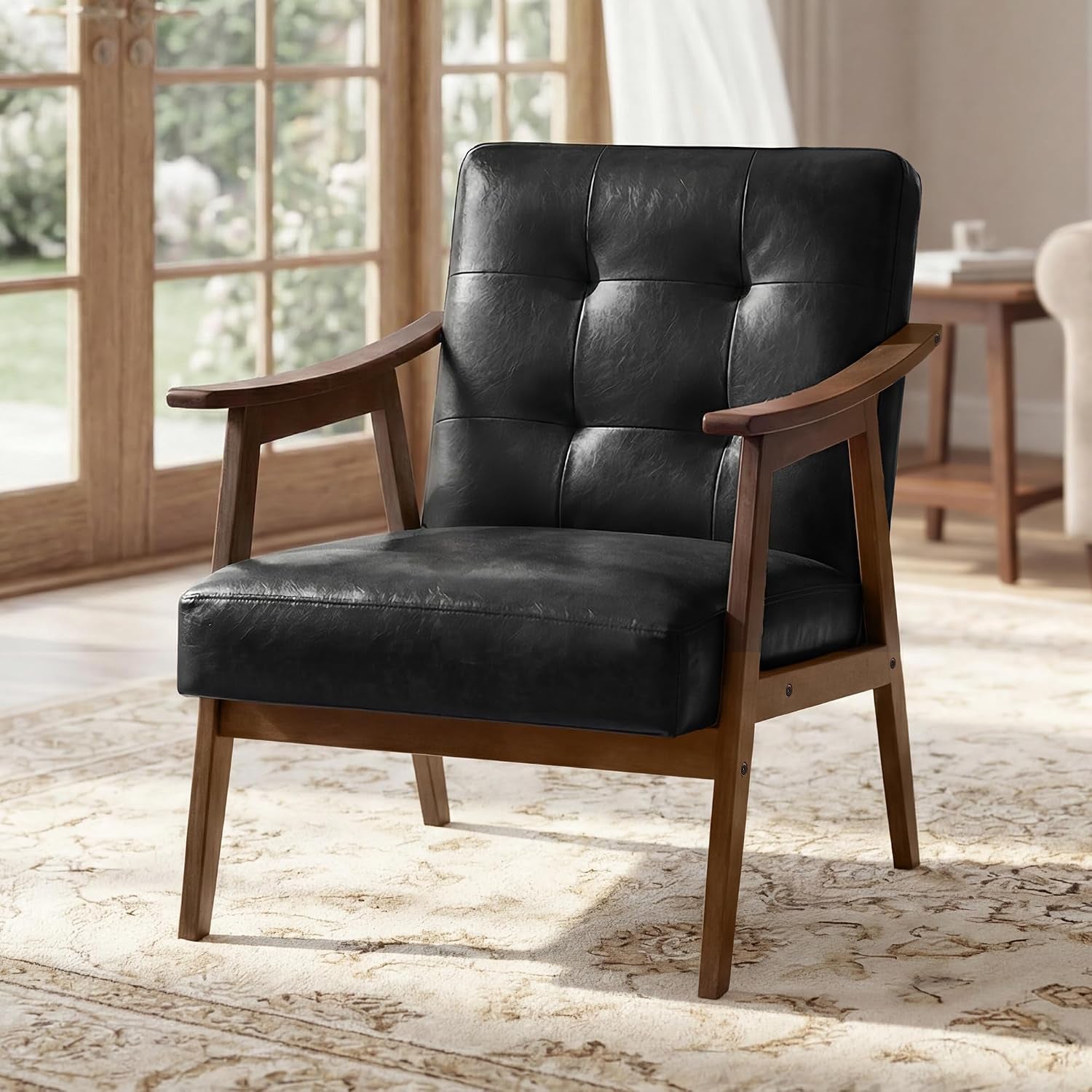 Black button-tufted mid-century armchair with warm wood frame on a patterned rug.