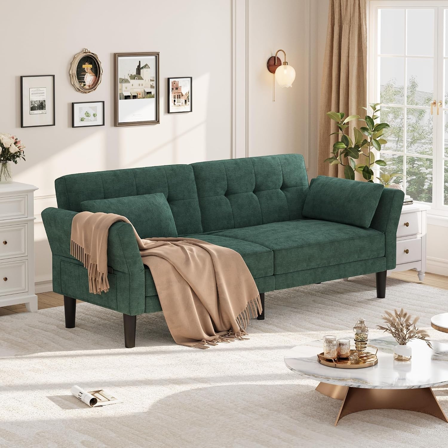 Front view of a green three-seat futon with a throw blanket draped over one arm