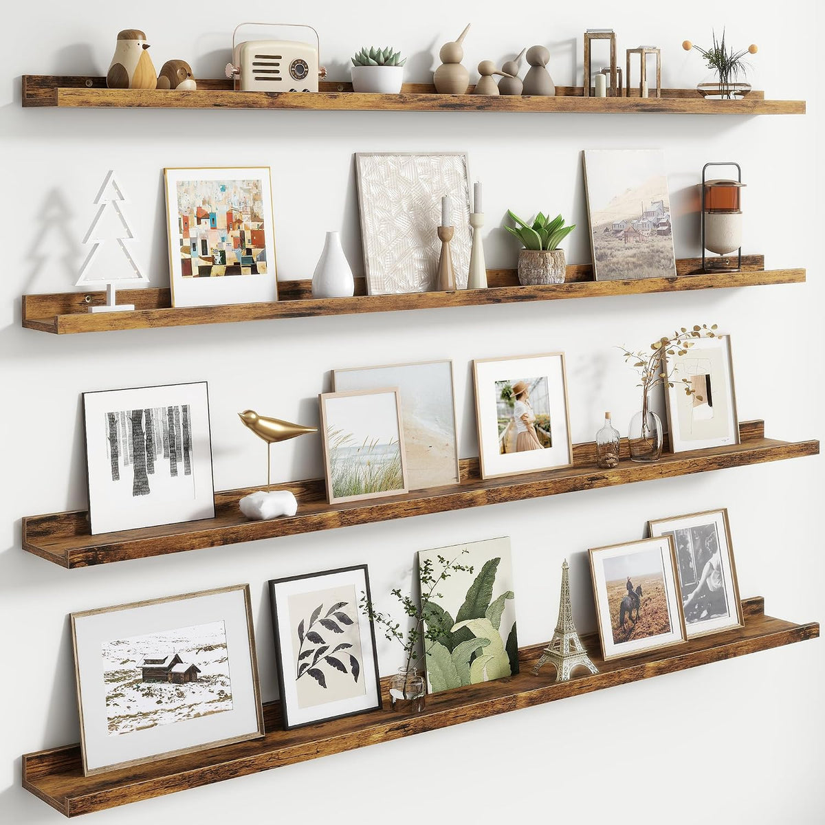 Long rustic brown floating ledges mounted on wall, holding framed art and small decor pieces.