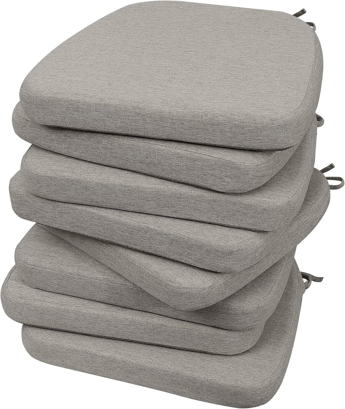Tall stack of six light gray D-shaped chair cushions seen from a slight angle with tie loops visible
