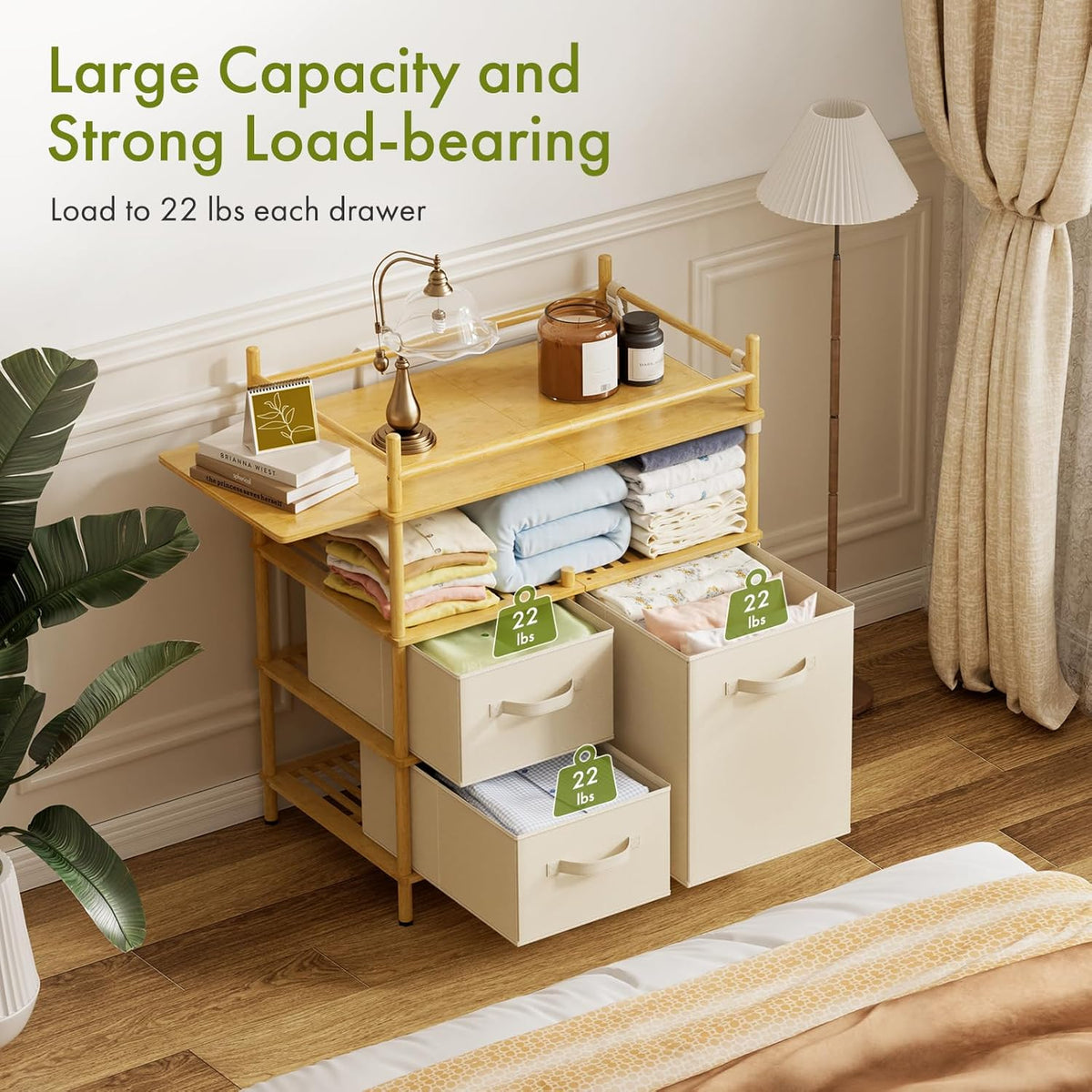Styled room view of the table with two drawers open, folded linens on shelves and tags indicating per-drawer load capacity.