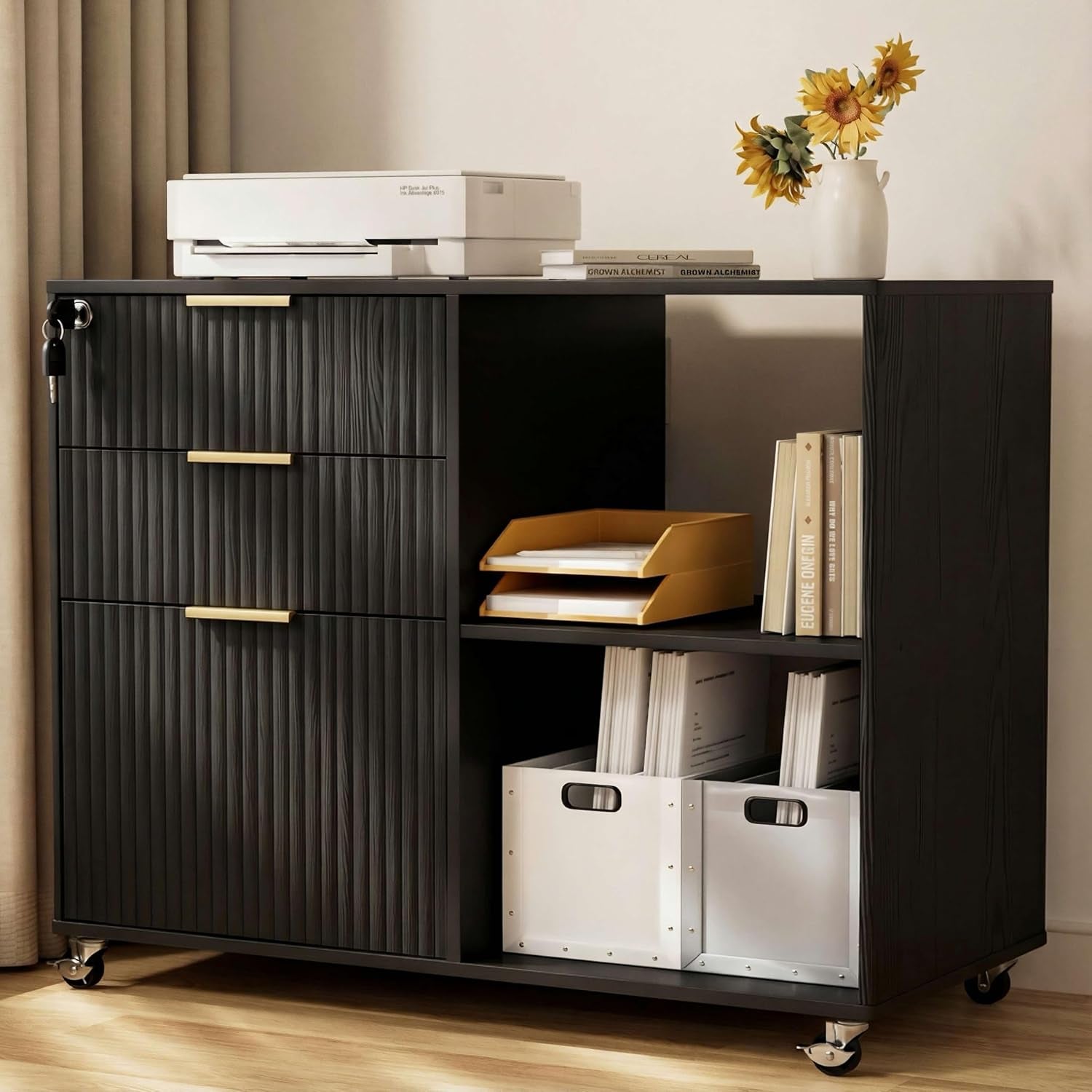 Close side view of a dark wood mobile file cabinet with fluted fronts and gold handles, styled with books and boxes.