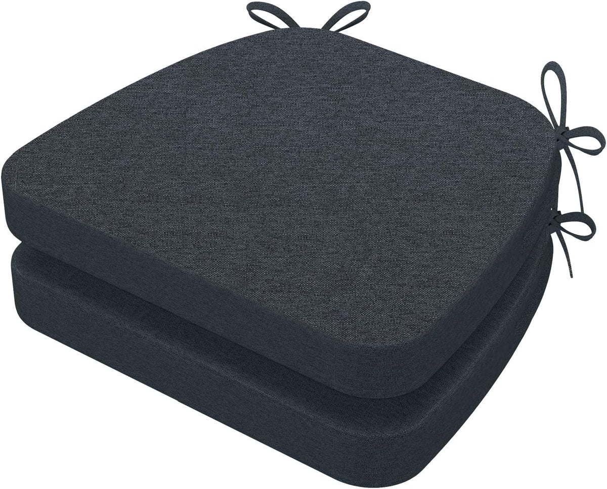 Angled top view of two dark charcoal D-shaped seat cushions stacked, ties looped at top and side.