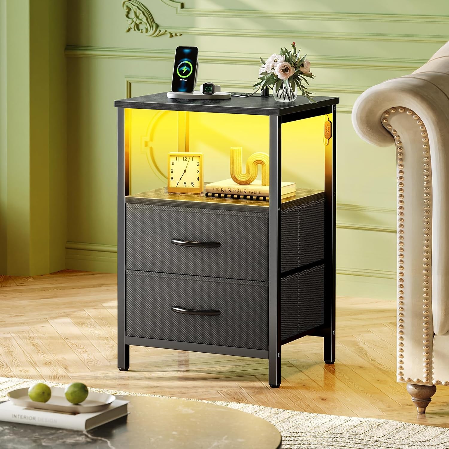 Black nightstand staged in living room beside sofa showing yellow LED light in open shelf