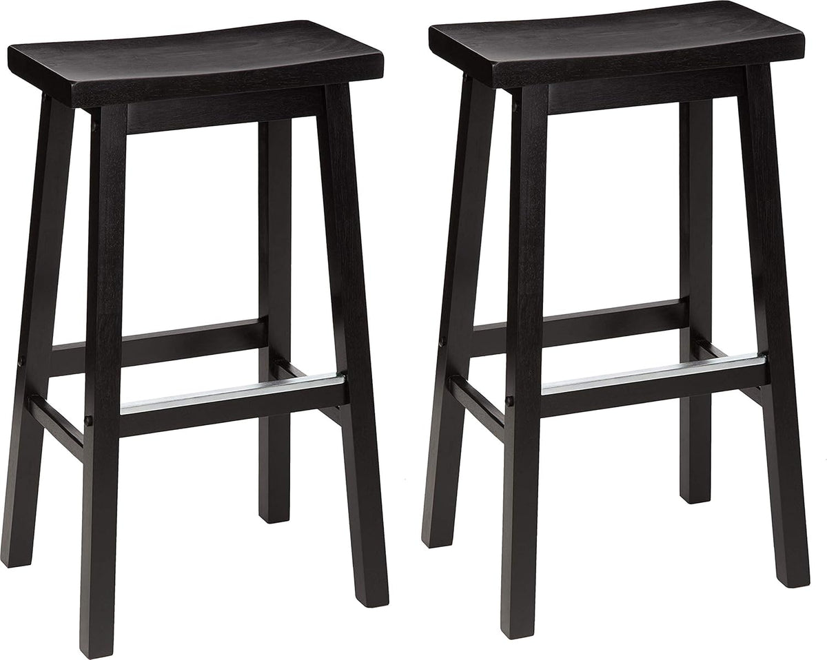 Pair of black wooden counter-height stools with saddle seats and metal-accent footrests shown side by side.