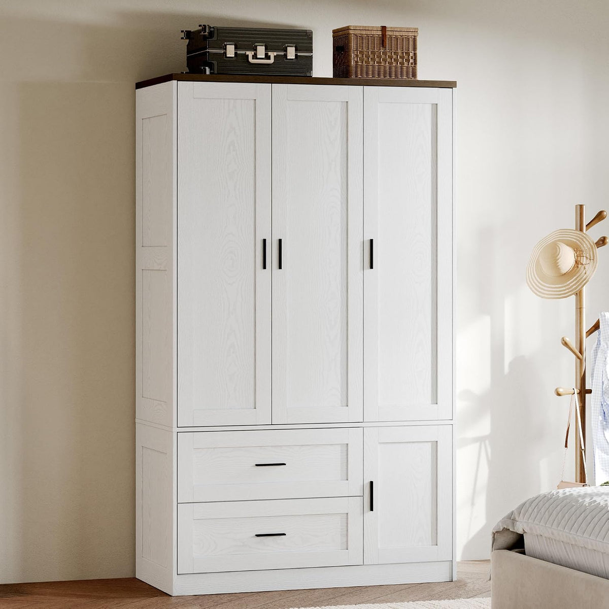 Close angled crop of the armoire upper doors and drawers showing black handles