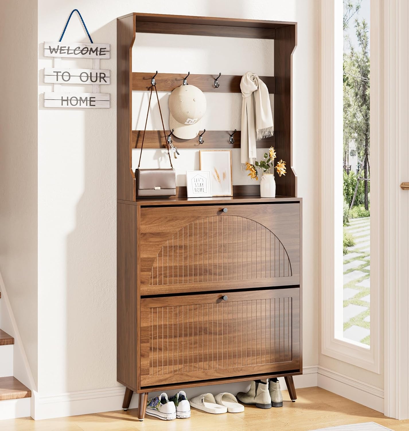 Walnut-finish shoe cabinet with two fluted flip drawers and upper shelf with hooks in entryway