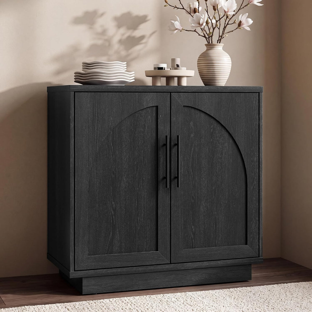 Front view of a compact dark charcoal sideboard with arched door insets and vertical handles.