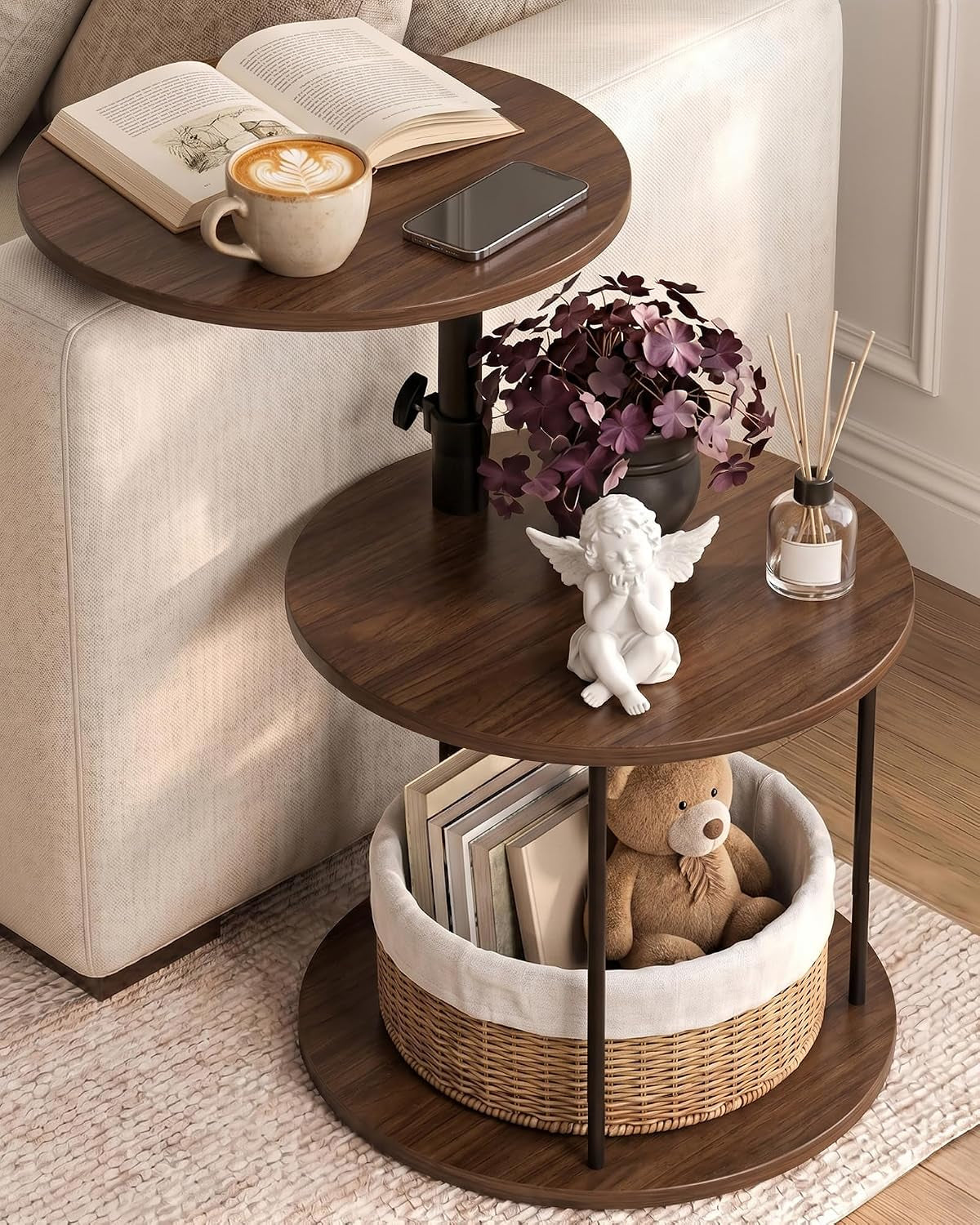 Round three-tier end table in a darker walnut finish beside a sofa, styled with a plant, angel figurine and basket