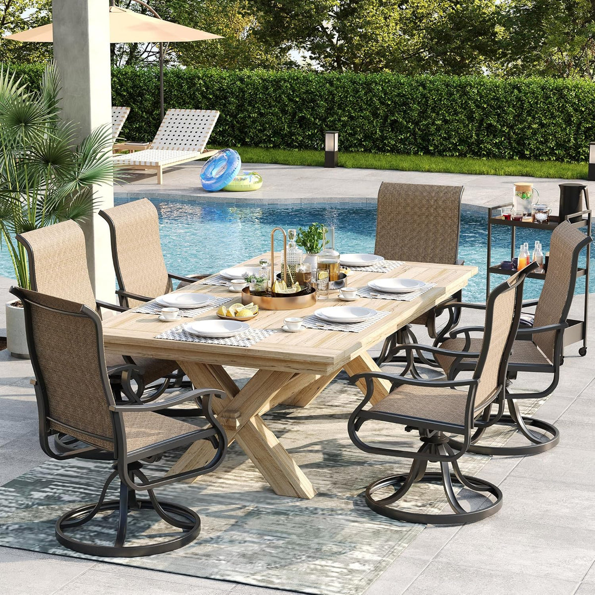 Outdoor dining scene with six brown high-back swivel rocking chairs around a rectangular wooden table by a pool