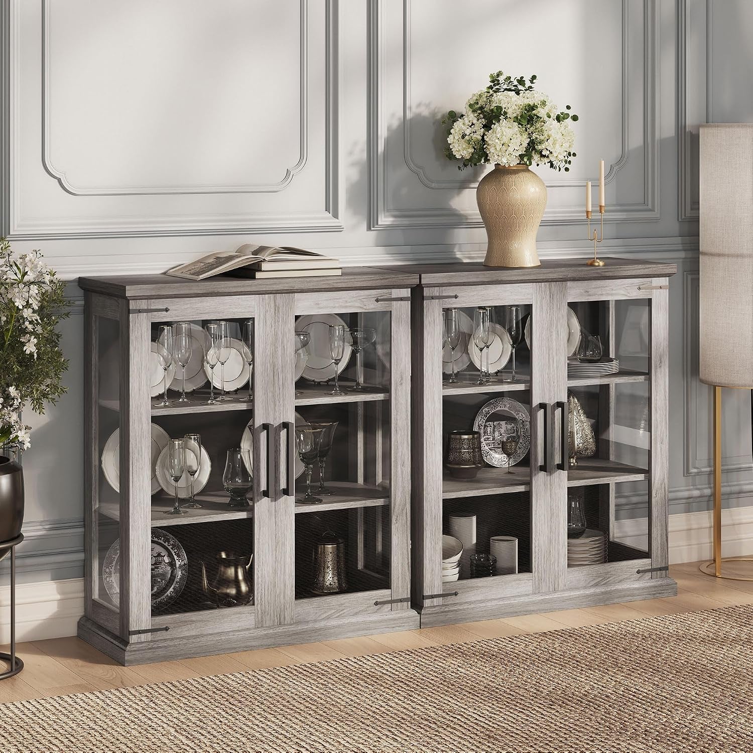 Low gray-wash display credenza with four glass doors showing dishes inside, styled in a living room setting