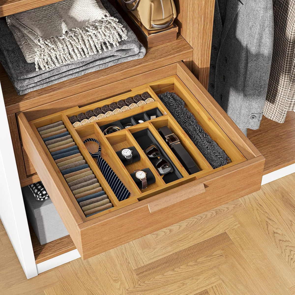Open wooden drawer with bamboo organizer holding ties, watches and sunglasses in a closet setting