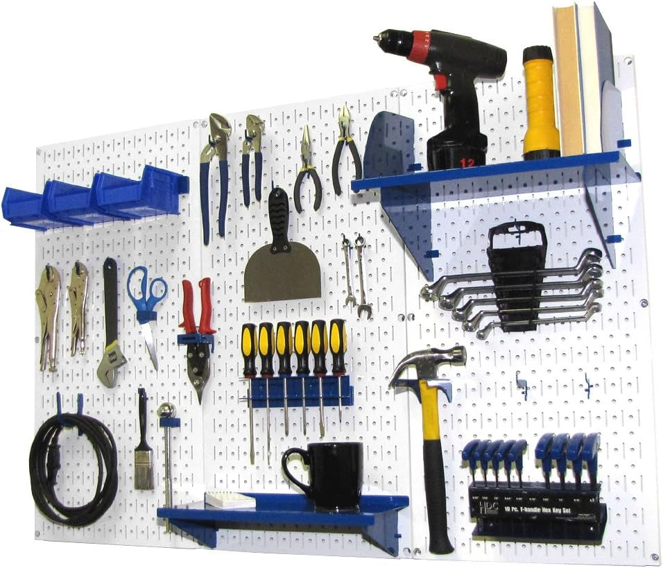 White metal pegboard wall filled with hooks, shelves and assorted hand tools neatly organized