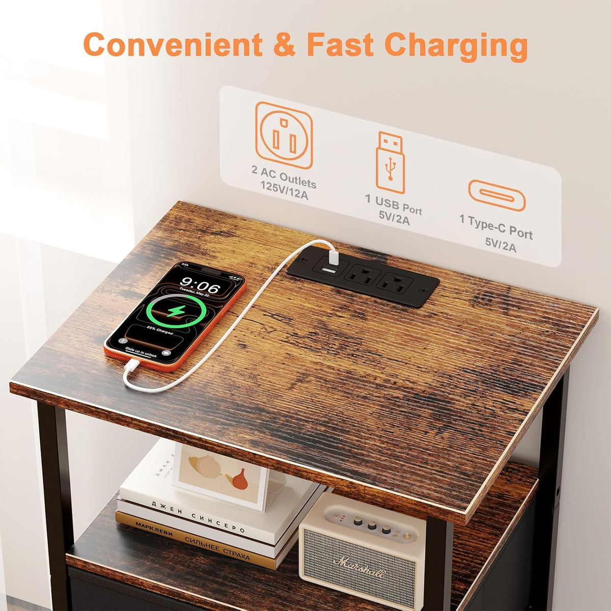 Close-up of the wood tabletop with a built-in charging panel, phone plugged in and items on the shelf below.