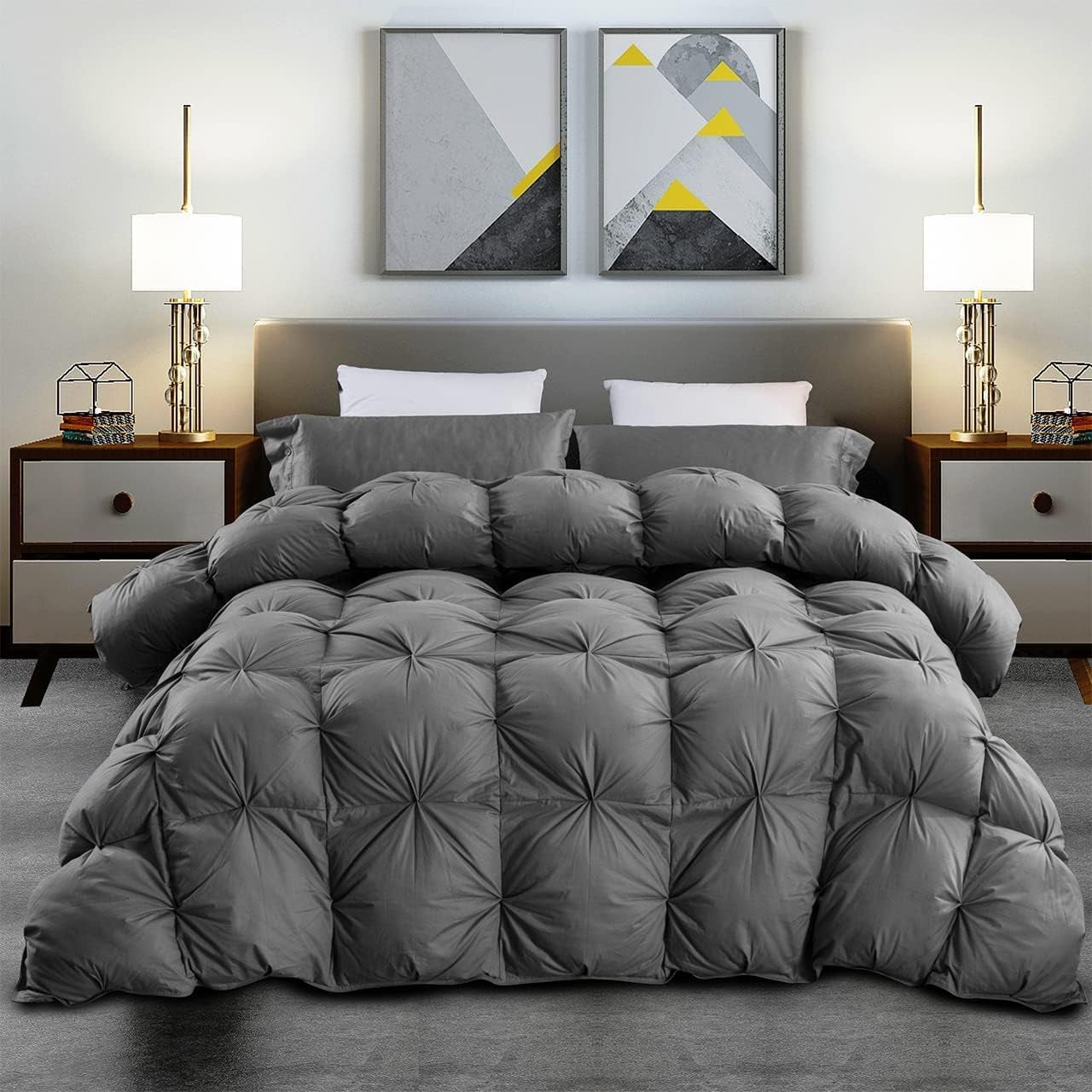 Bedroom scene with a tufted, dark comforter draped over a bed and matching pillows.