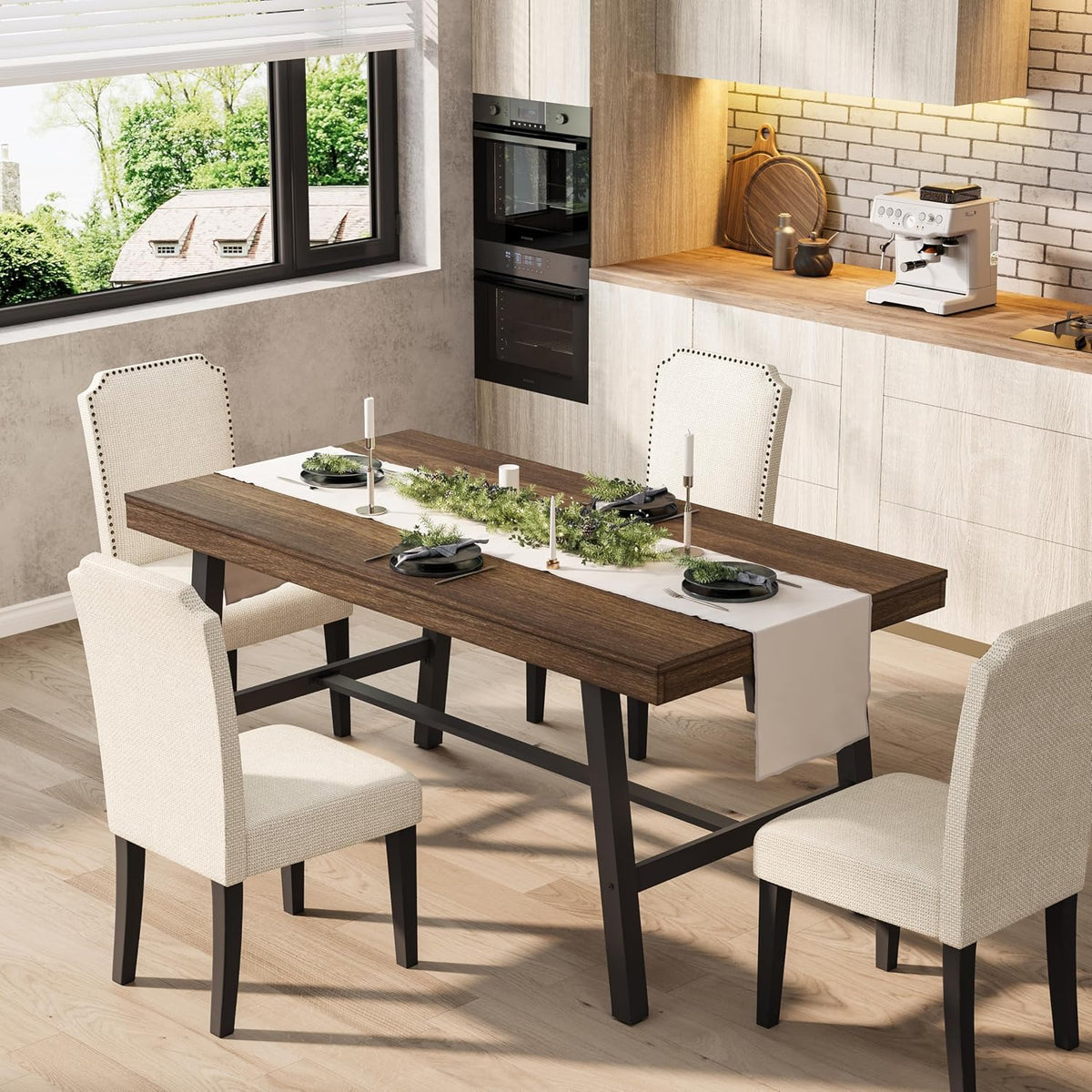 Three-quarter view of the brown wood tabletop and black trestle base in a kitchen with cream nailhead chairs.