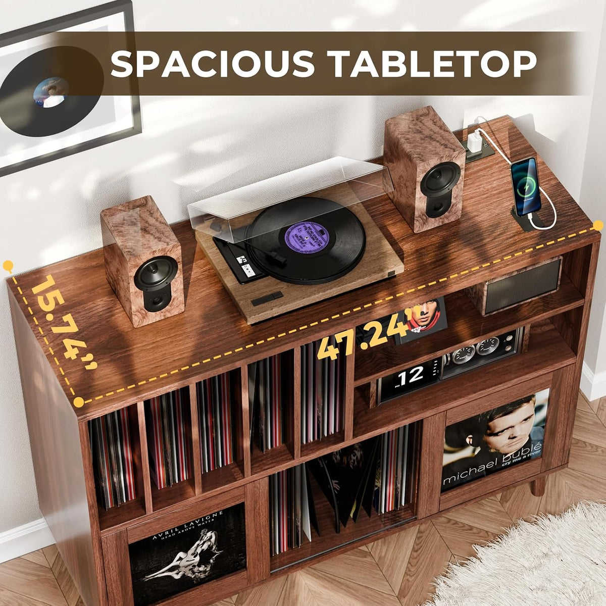 Angled overhead view of the spacious wood tabletop with a turntable and speakers placed on it.