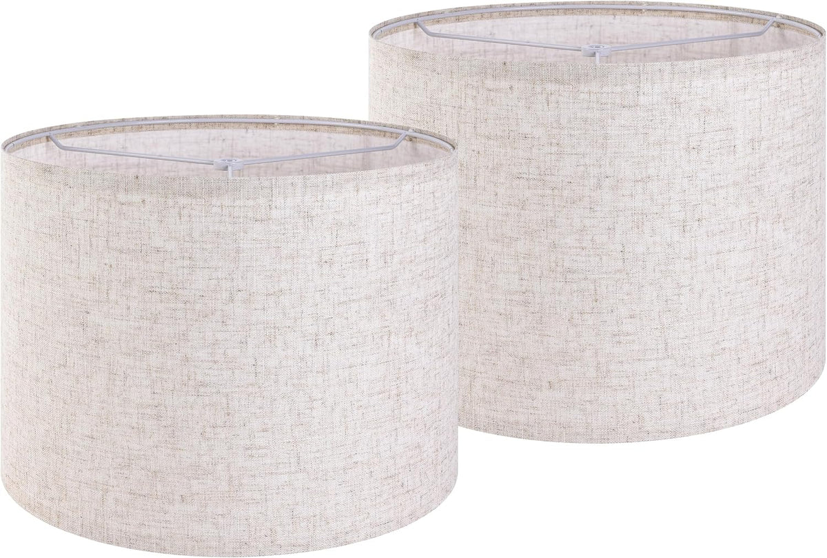 Pair of off-white textured linen drum lamp shades shown together on white background.