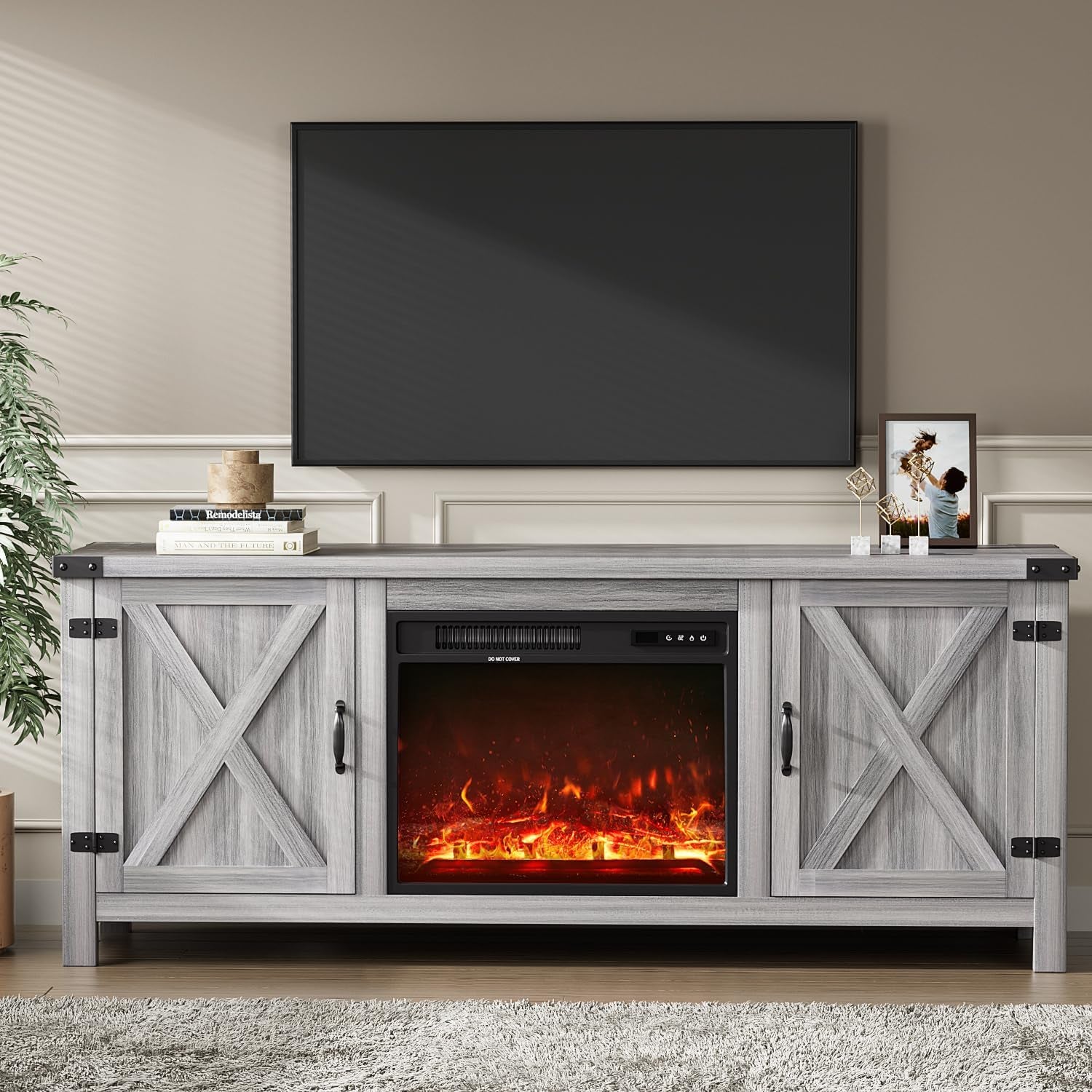 Front view of a gray-wash farmhouse TV stand with X-panel doors and an illuminated electric fireplace.