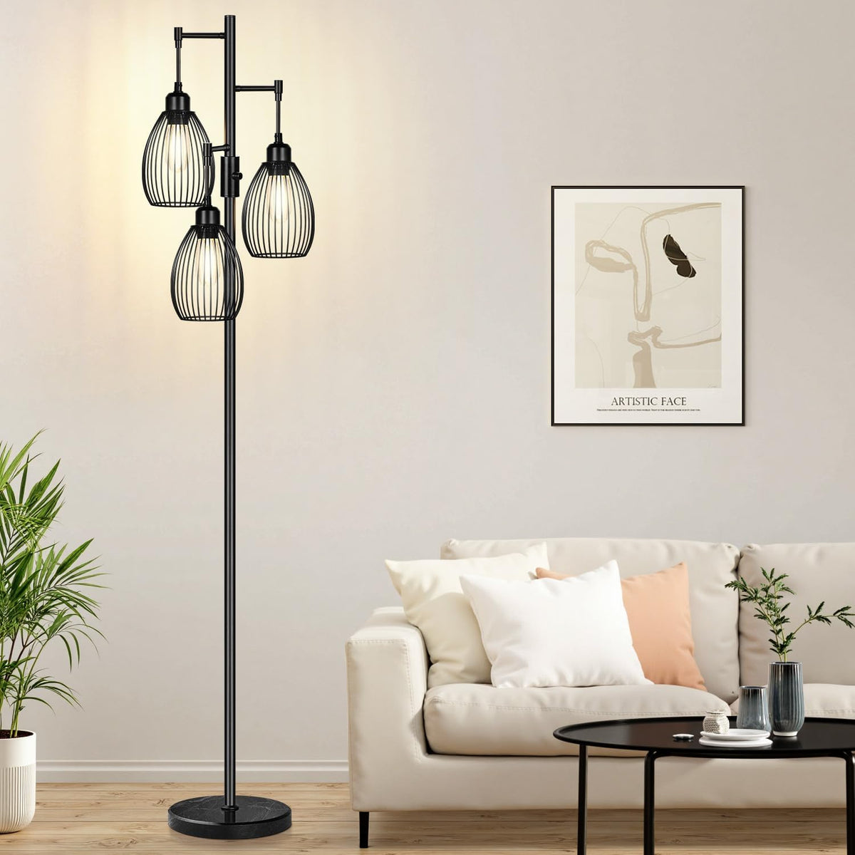 Black three-light floor lamp with slender pole and cage shades standing by a beige couch and black coffee table.