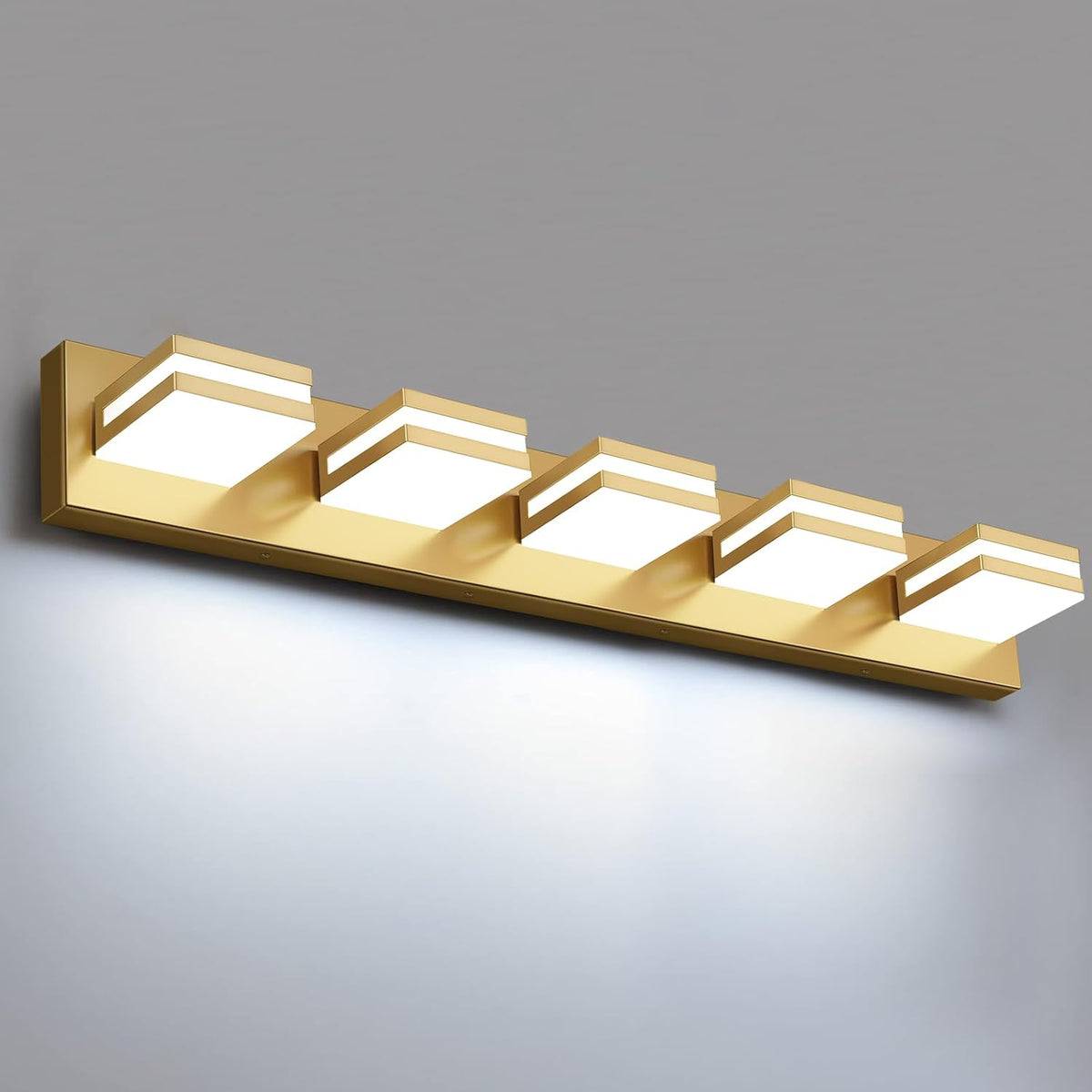 Angled view of a gold finish LED vanity light with five illuminated square modules.