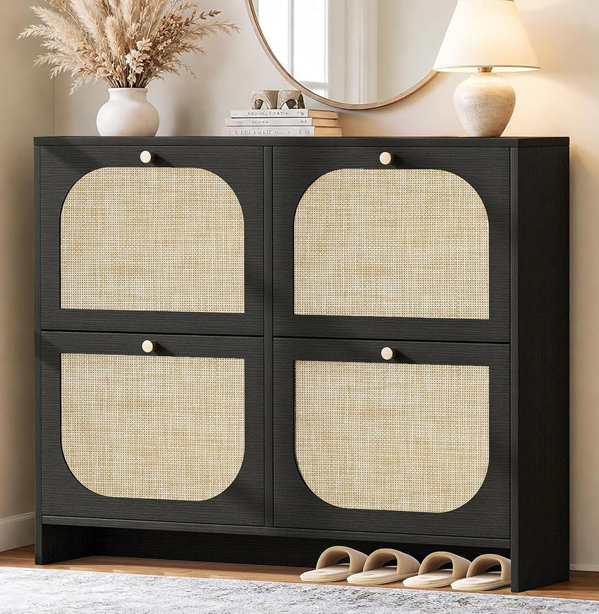 Black shoe cabinet shown front-on with rounded-arch rattan panels in each quadrant and decorative items on top.