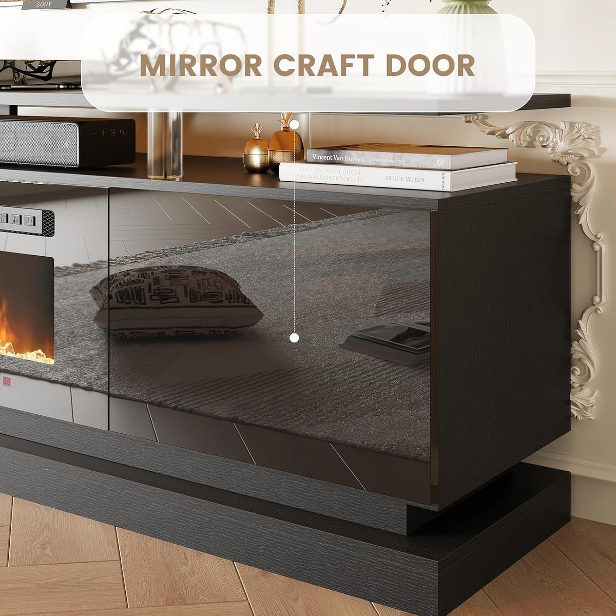 Close-up of mirror-finish cabinet door and textured layered base on a black TV stand