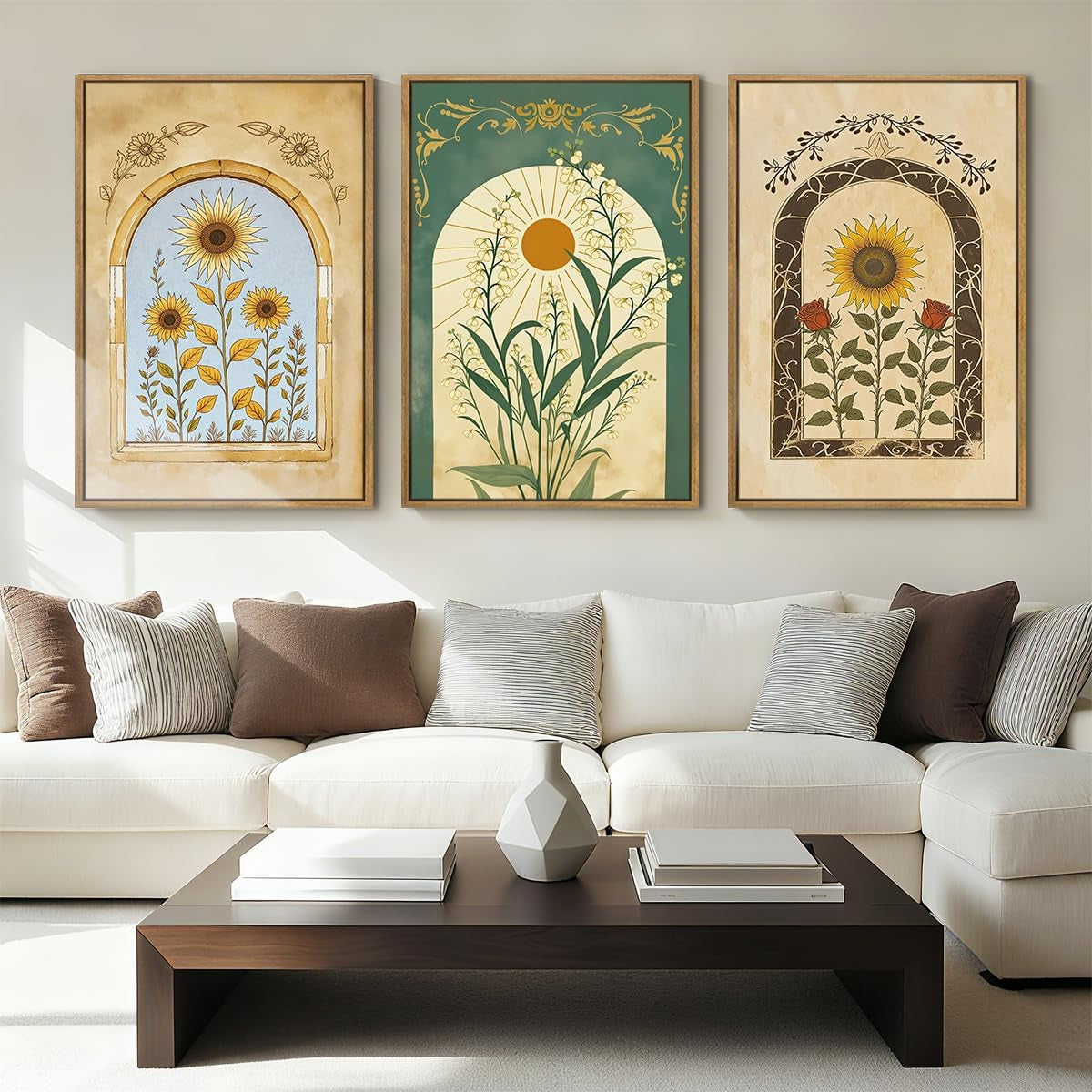 Three colorful floral prints with arched panels in wood frames arranged above a sofa and dark wood coffee table.
