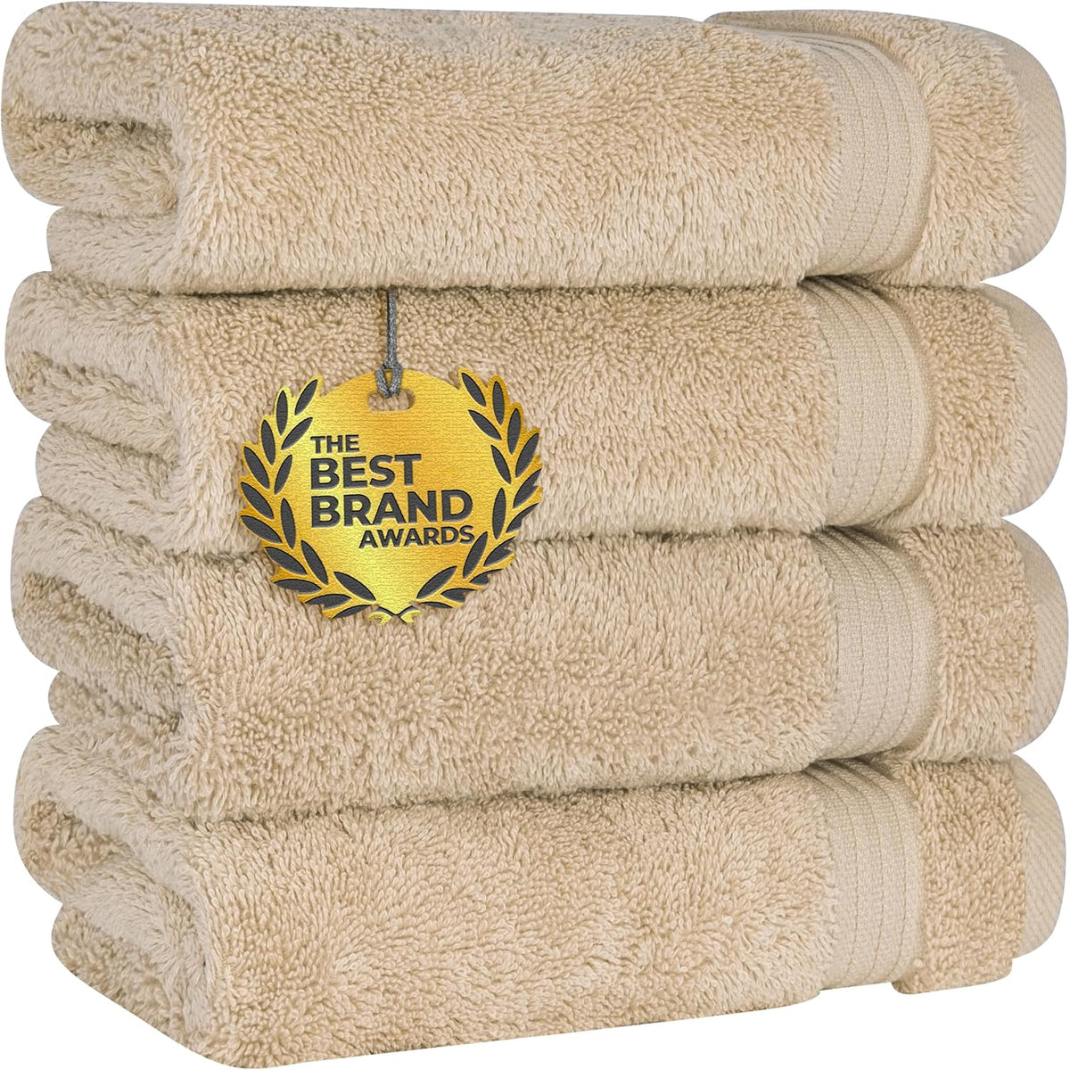 Angled stack of warm beige towels with a gold award medallion draped over the front