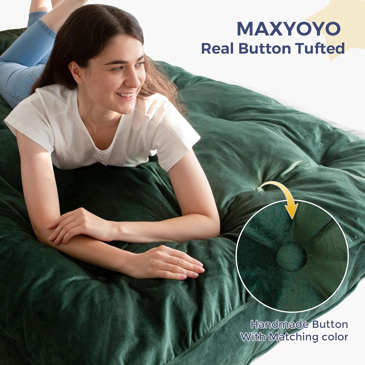 Close view of a dark green tufted futon mattress with a person resting and a visible button tuft.