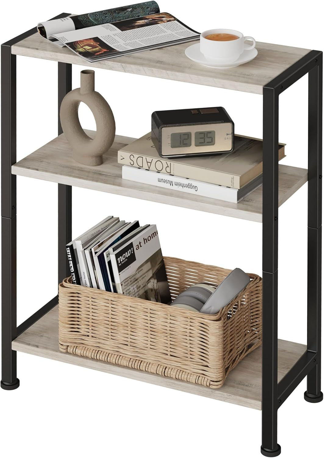 Three-tier narrow side table with light reclaimed-wood shelves and black metal frame holding cup, clock, and basket
