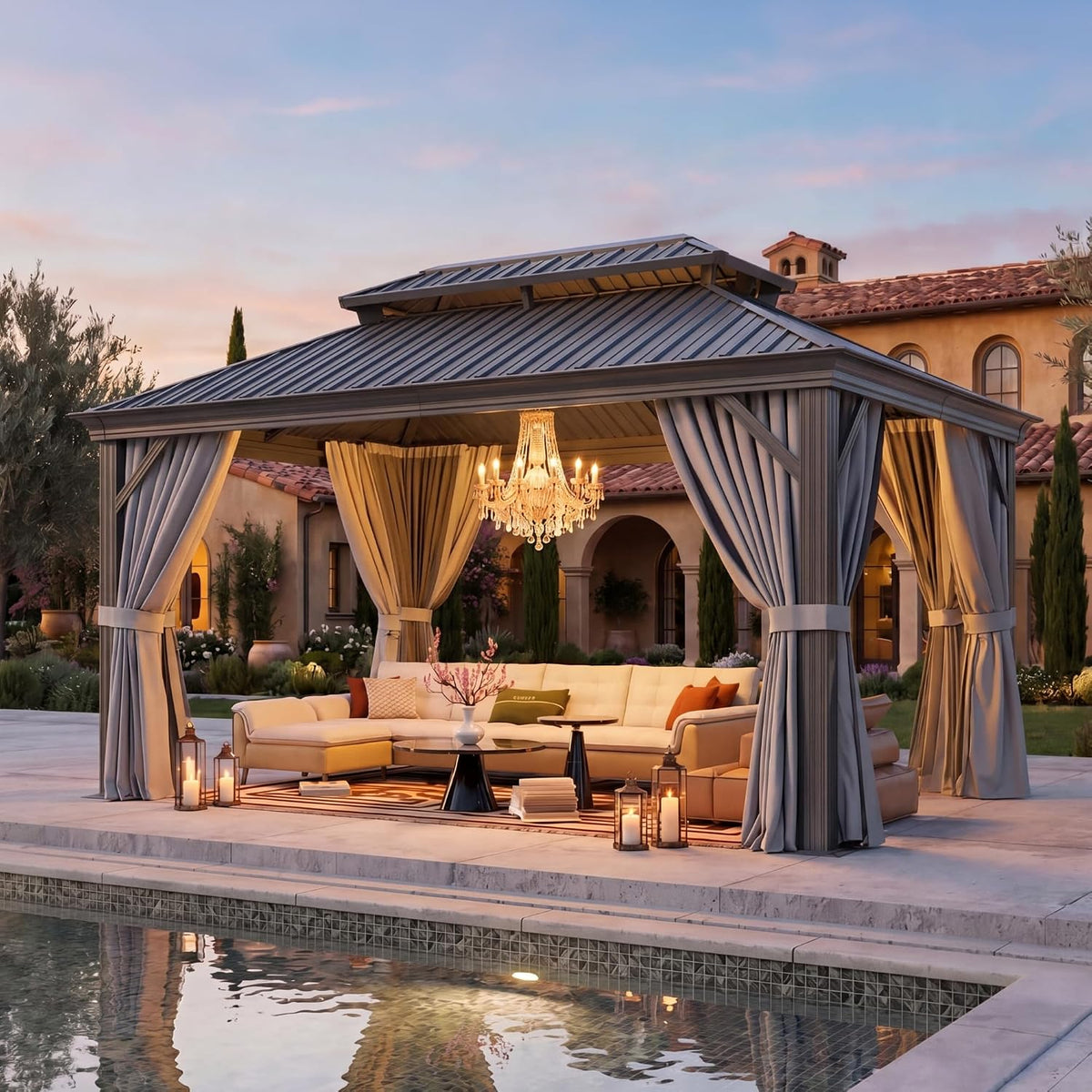 Evening outdoor scene of the gazebo on a paved patio with tied curtains, lanterns on the floor and a sectional seating area