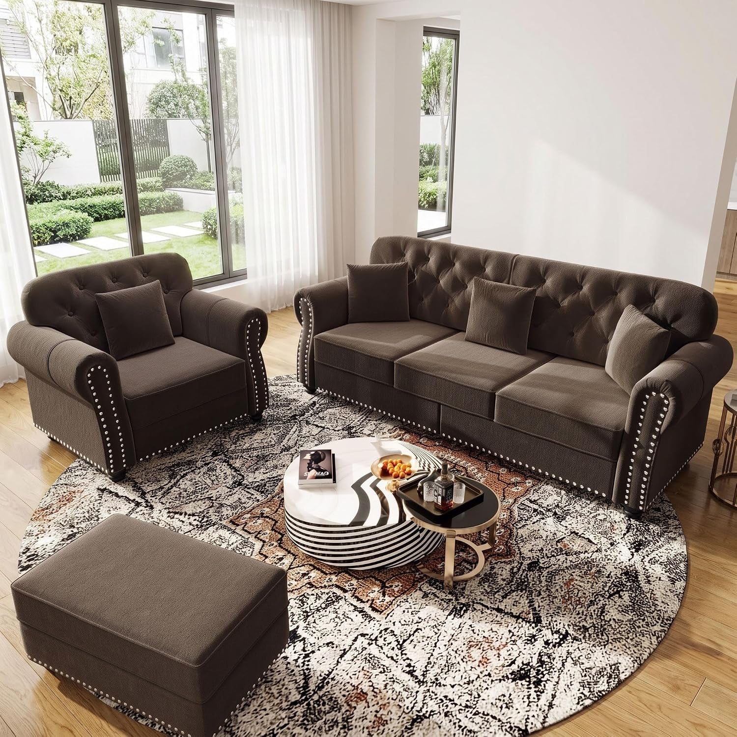Brown Chesterfield sofa set with ottoman and two-tiered round coffee tables on a round rug