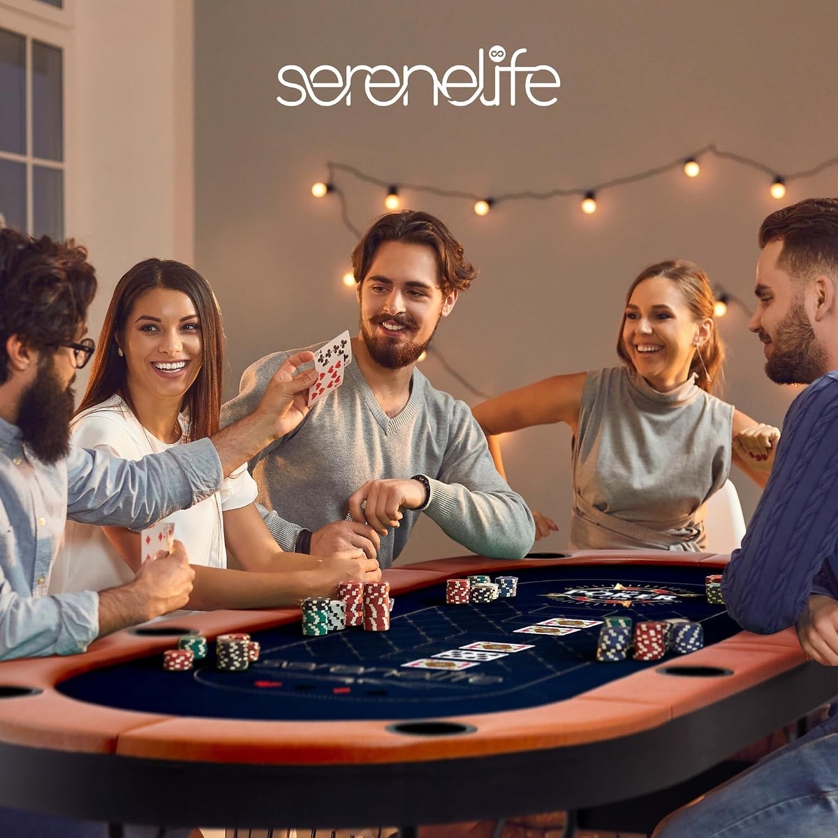 Mid-shot of five friends around an oval poker table; one player holds up cards as others smile under warm string lights.