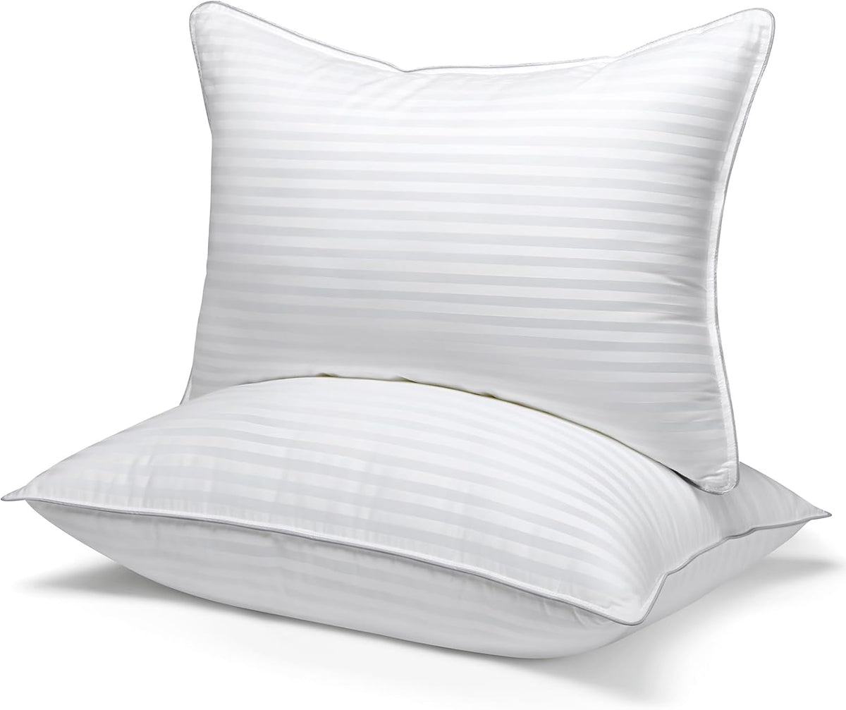 Two white pillows stacked showing a faint satin stripe pattern across the fabric