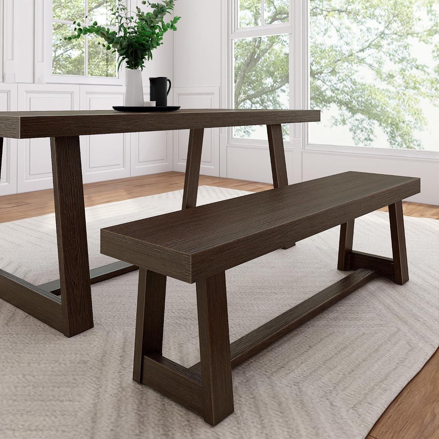 Dark brown rectangular dining bench paired with matching table leg in bright room