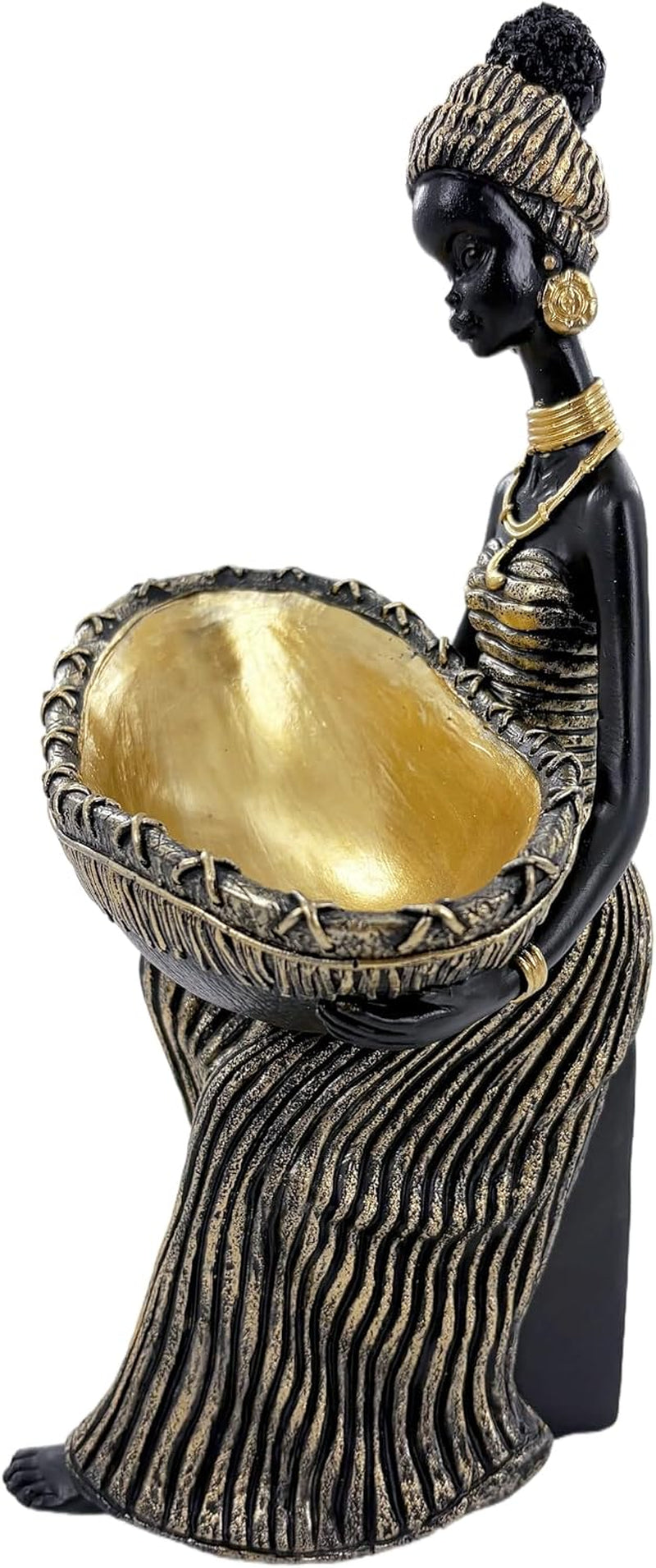 Side view of a seated black-and-gold female figurine holding a shallow gold bowl in her lap.