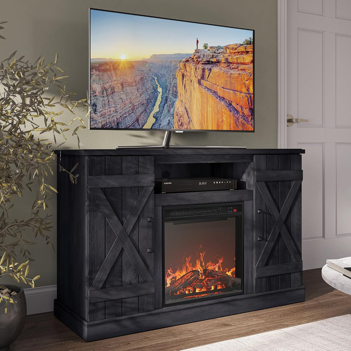 Close angled view of a dark charcoal farmhouse TV stand with lit fireplace and TV on top