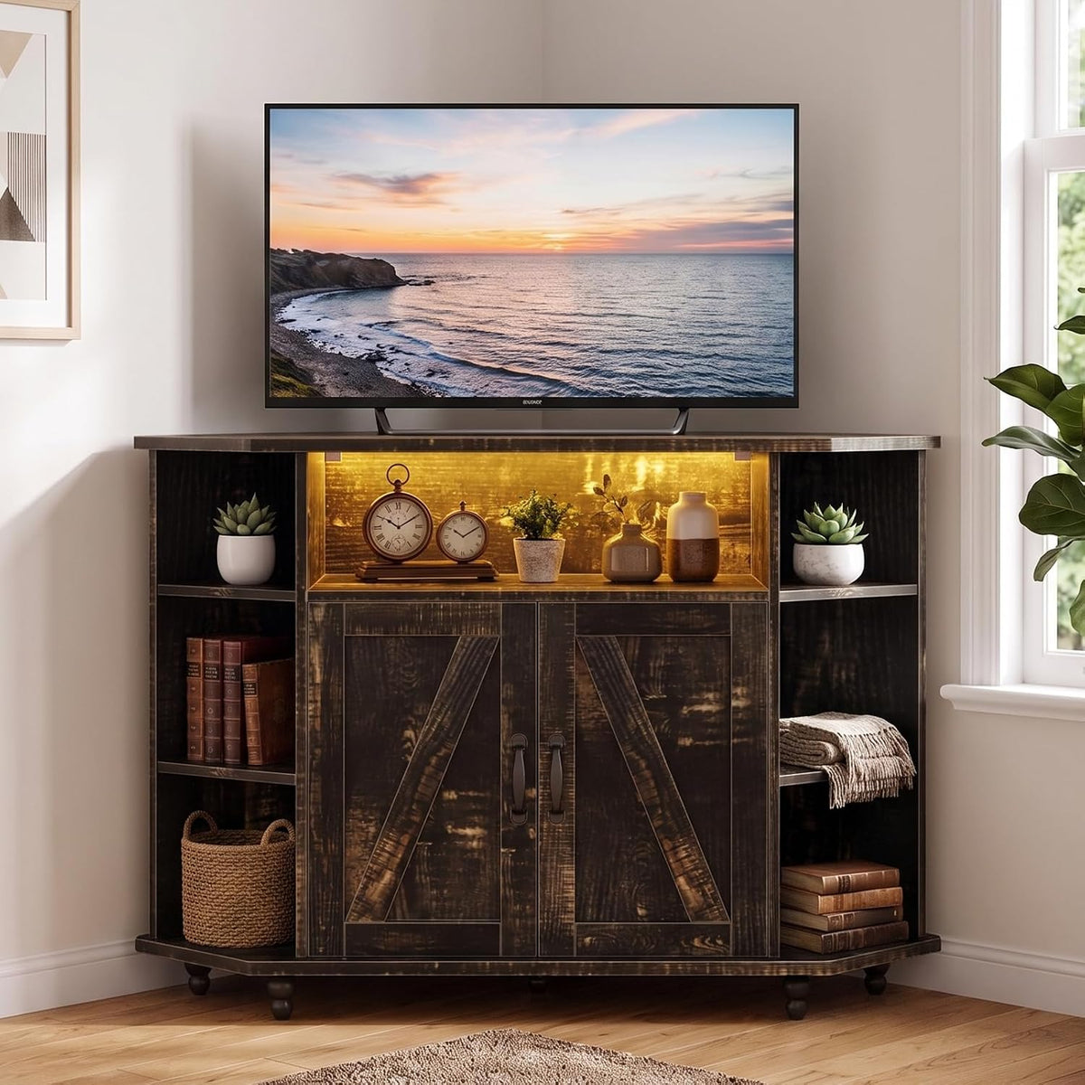 Front view of a dark distressed corner TV stand with barn-door cabinet, side cubbies, woven basket and lit center shelf.