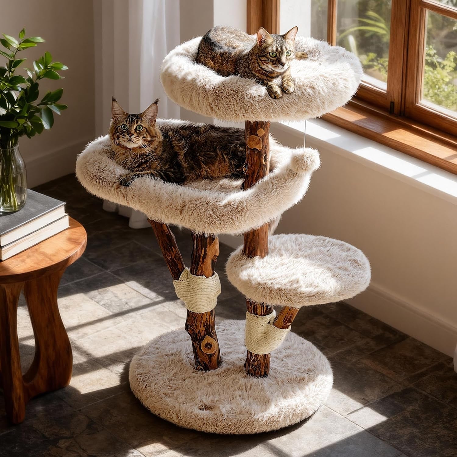 Beige faux-fur cat tree with three plush perches and real wood posts beside a window.