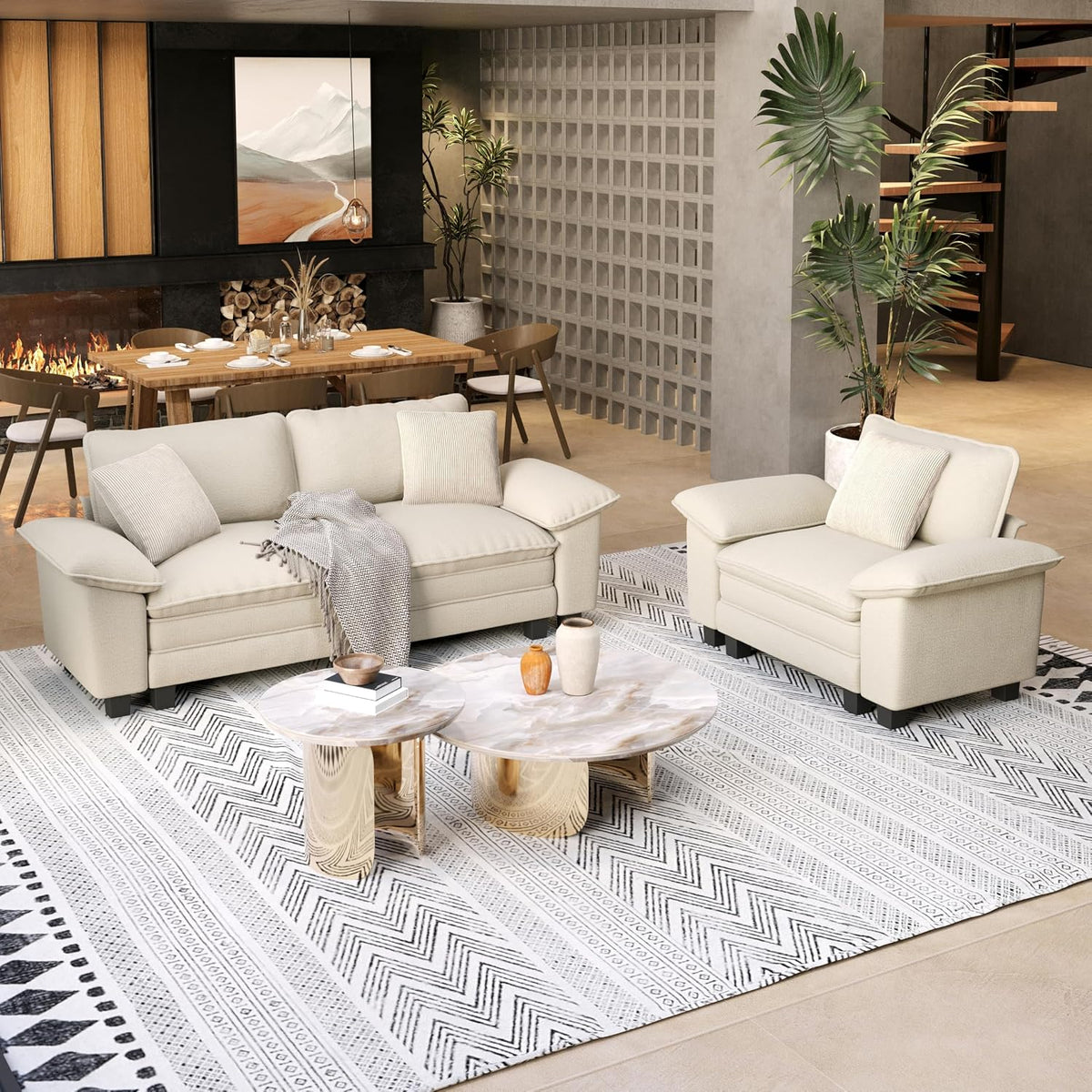 Cream three-seat sofa and matching armchair on patterned rug in a modern living room.