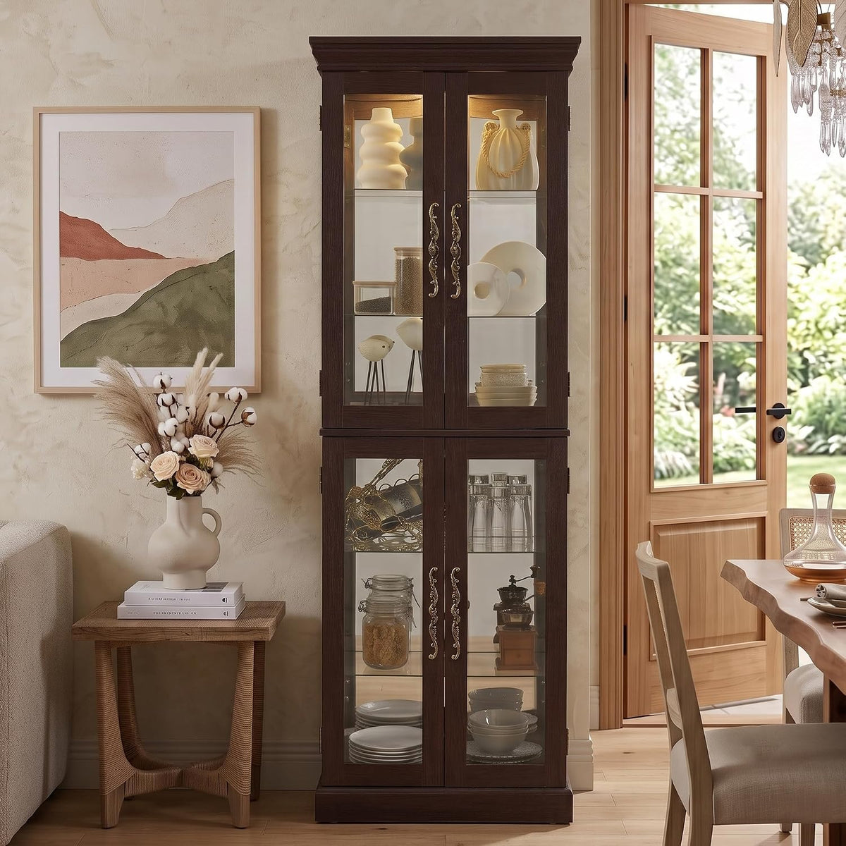 Full-room shot of the cabinet in a dark wood finish, lit interior shelves, placed beside a door and framed artwork.