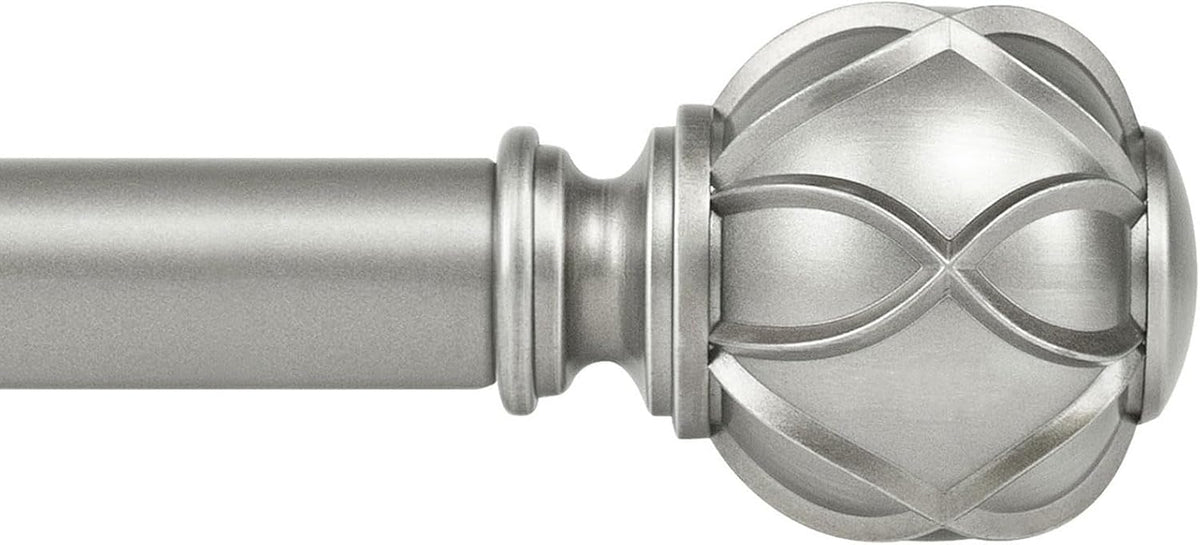 Close-up of a silver metallic curtain rod end and ornate rounded finial with intersecting ribbon-like grooves.