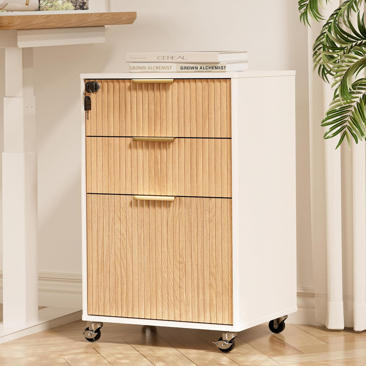 White-bodied mobile file cabinet with oak ribbed front, three-quarter front view beside a desk and plant