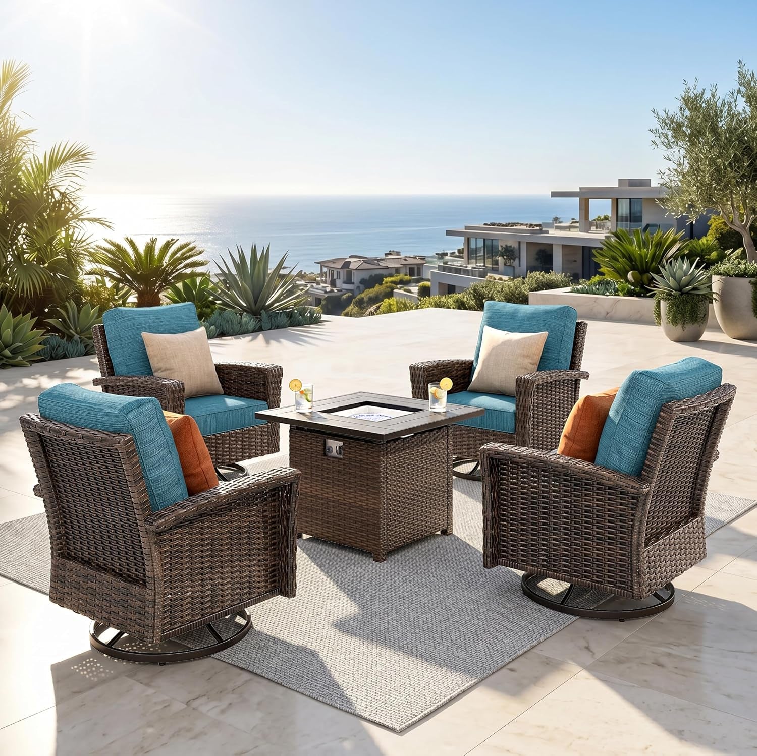 Outdoor patio set with four brown wicker swivel chairs and a square fire table, blue cushions and coastal view.