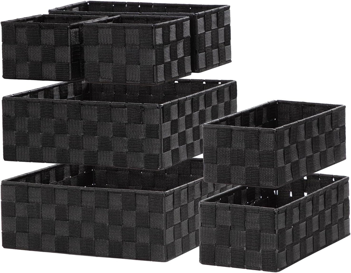 Perspective view of black woven baskets with one mid-size basket slightly pulled forward.