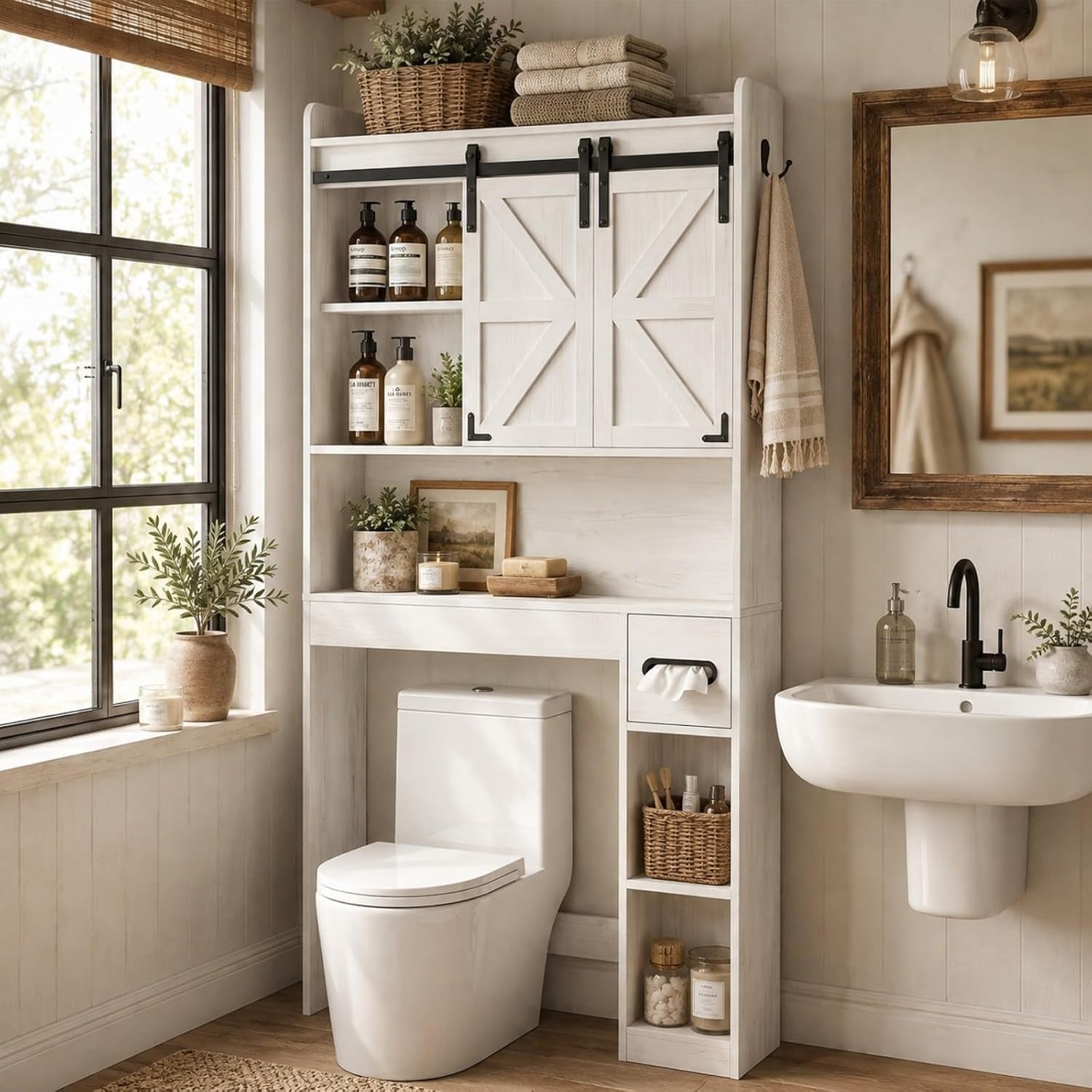 Whitewashed over‑toilet cabinet with sliding barn doors, open middle shelf and right‑side cubby storage.